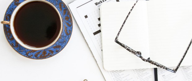 Coffee, crossword and galsses on a table