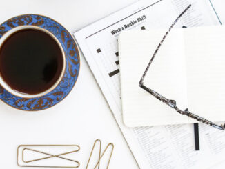 Coffee, crossword and galsses on a table