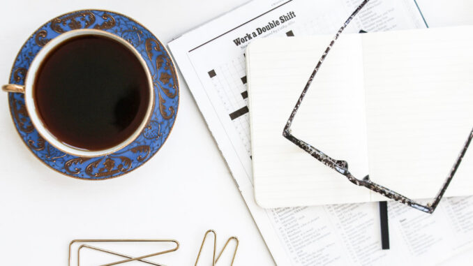 Coffee, crossword and galsses on a table