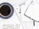 Coffee, crossword and galsses on a table