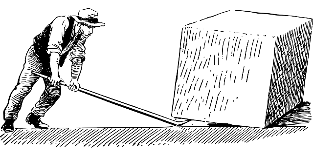 An image of a man using a lever to move a box