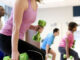 Picture of poeple in a gym doing exercises.